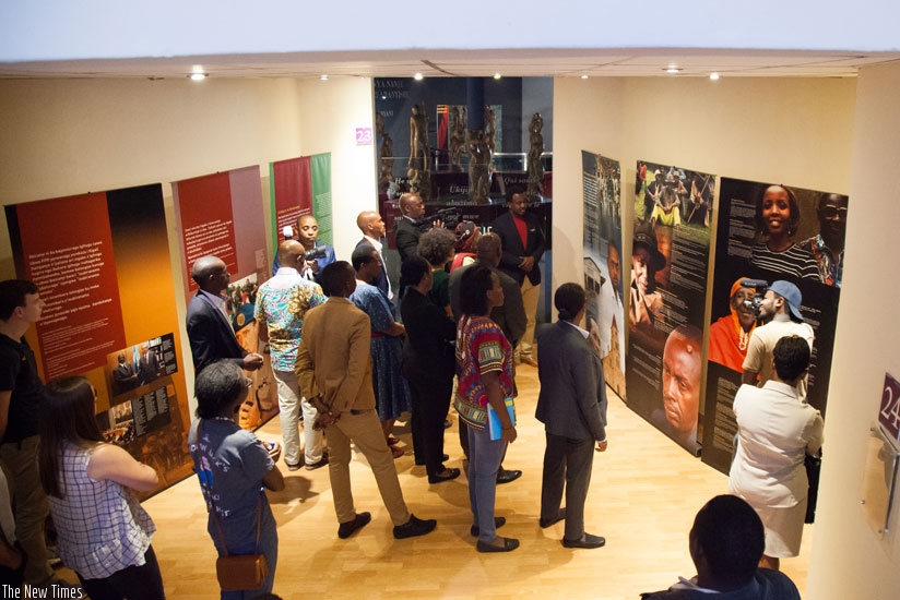 Visitors read messages on the Genocide at Kigali Genocide Memorial Centre. (T. Kisambira)