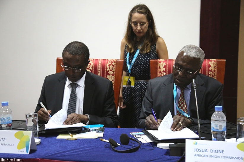 The Minister for Natural Resources, Dr Vincent Biruta (L), and Dr Josua Dione, senior advisor to the African Union Commissioner for Rural Economy and Agriculture, sign the 'Kigali ....