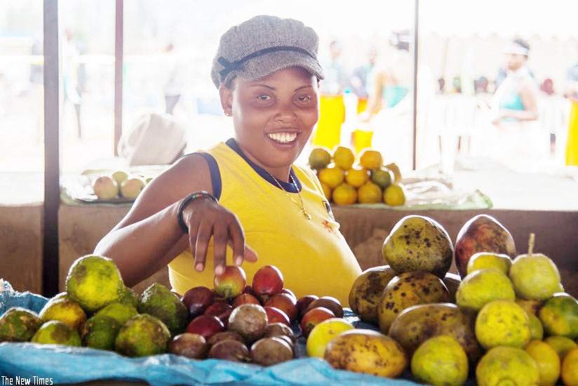 One of the beneficiaries of Kimisagara minimarket in Nyarugenge district pose for a photo with her business.