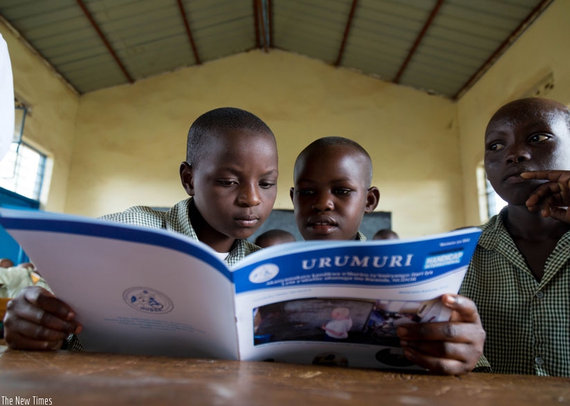 Pupils read a magazine at GS Bumbogo in Gasabo District. (T. Kisambira)