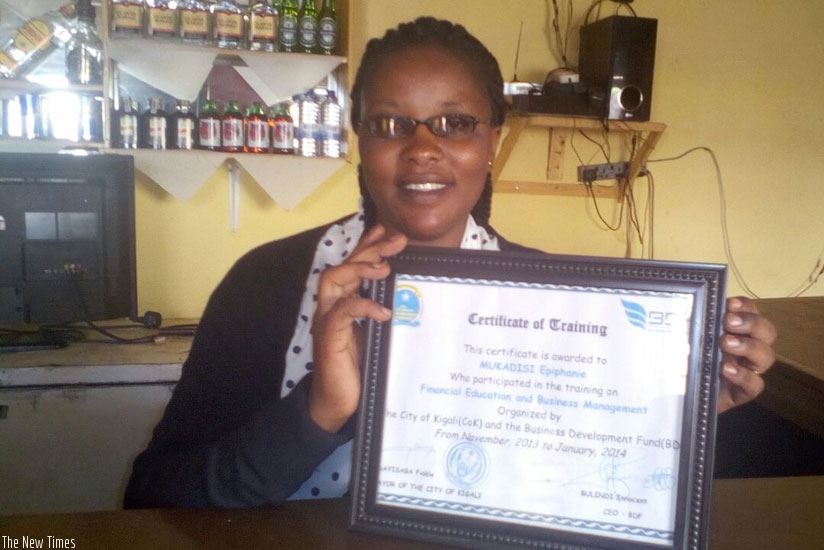 Mukadisi poses with a certificate issued after a workshop by BDF. / Elias Hakizimana.