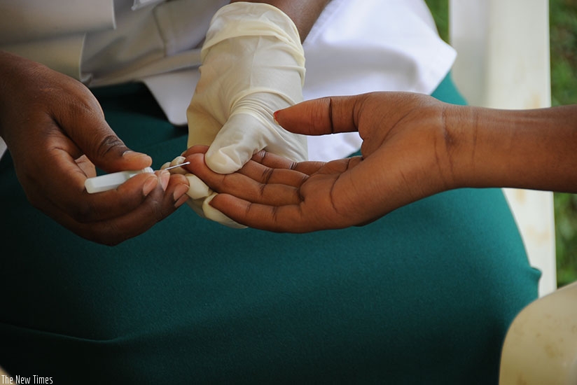 A health worker takes blood samples for HIV test. / File.