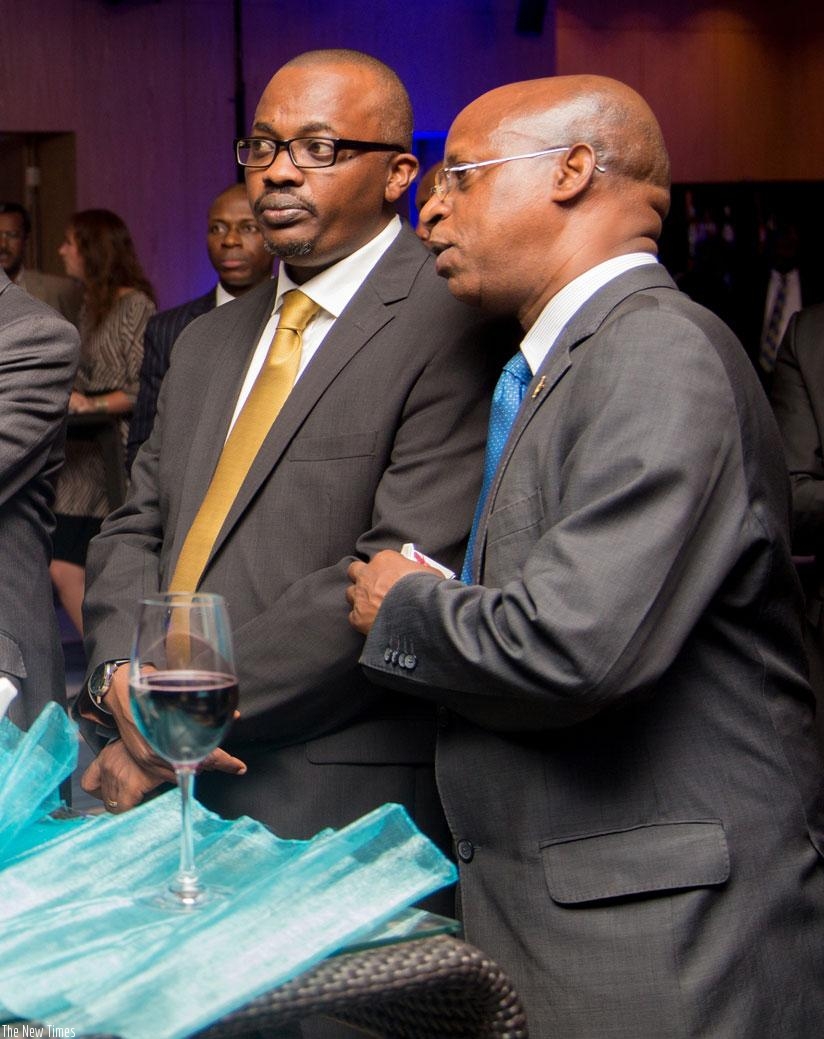 Chief Executive Officer of the Business Development Fund, Innocent Bulindi (L) chats with Joseph Mungarulire, the director general of NIRDA (Photos by Faustin Niyigena)
