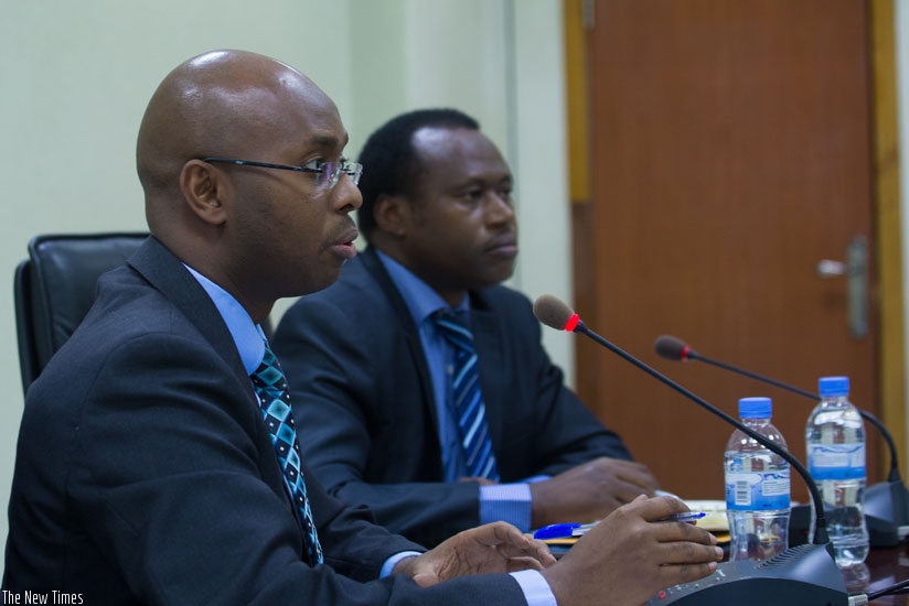 The Director-General of the National Institute of Statistics of Rwanda, Yusuf Murangwa (L), explains results of the gross domestic product for the second quarter as Dr Uzziel Ndagi....