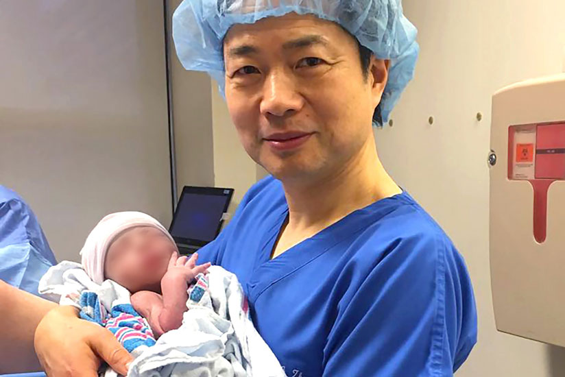 Dr John Zhang with the world's first baby born using DNA from three people. The baby is reported to be healthy. Photograph: New Hope Fertility Center