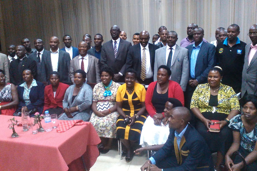 The delegation from Muntuyera High School - Kitunga poses for a group photo with Minister Busingye (5th left, standing) and Uganda's High Commissioner to Rwanda Amb. Kabonero (cent....