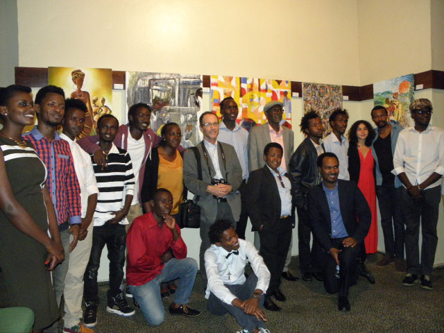Local artists pose with the French filmmaker David Helft (centre in a suit) at the premiere of the 'In the Eye of the Artist' documentary. / Donata Kiiza.