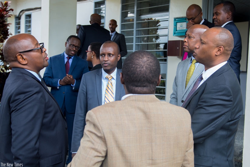 Musoni (L) shares a light moment with other officials after signing Imihigo for MININFRA yesterday. (T. Kisambira)