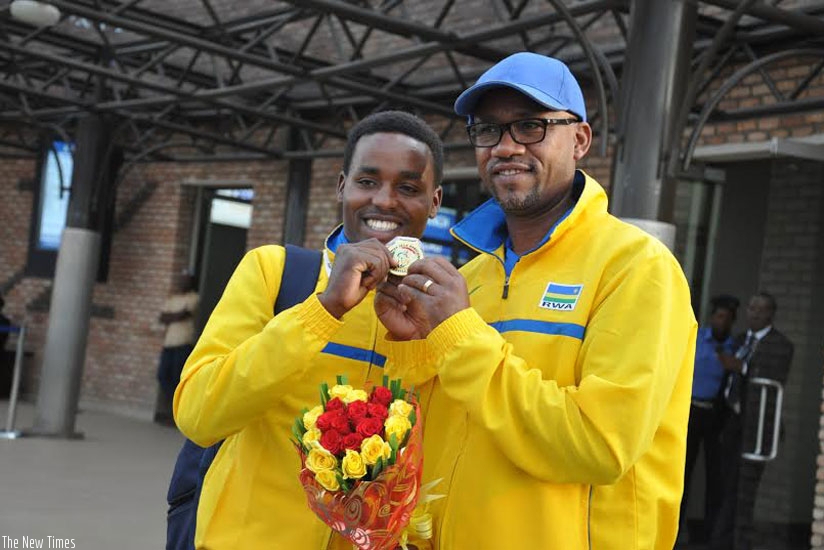 FERWACY president Bayingana (R) with Hadi show off the gold medal the Rwandan rider won at the 2015 All-Africa Games Road Race. (File photo)