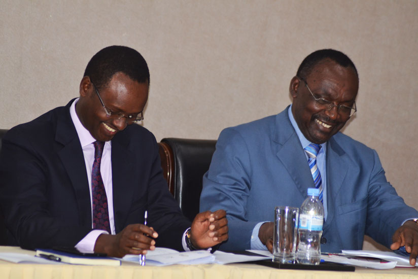 Minister Kanimba (R) and Trade and Industry ministry permanent secretary Emmanuel Hategeka share a light moment during the launch of the National Trade Committee in Kigali yesterda....