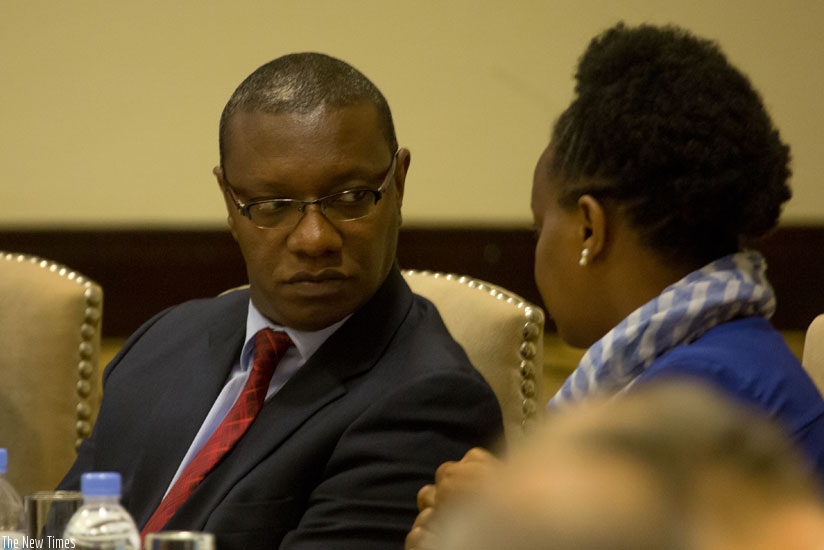 Dr Ndimubanzi (L) chats with Dr Condo at the launch on Wednesday. (T. Kisambira.)