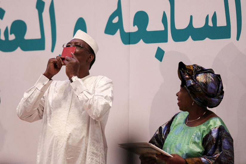 Chad President Idriss Deby, who is also the current AU chairman, shows off the new African Passport during the AU summit in Kigali. / Net photo.