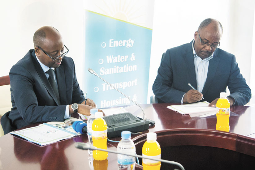 REG Chairperson Prof Masasse Mbonye signs Imihigo with Minister Musoni on last Monday. / Faustin Niyigena