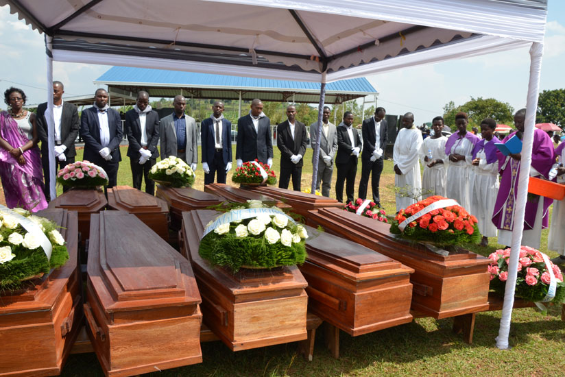 Bosco Ntagungira (4thR), a priest, leads prayers attended by Gasabo local government officials at the burial. / Elias Hakizimana. 