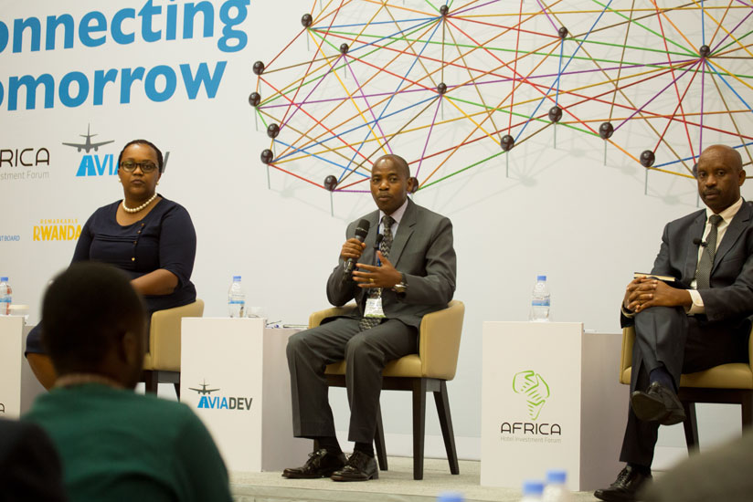 Pascal Nzaramba, deputy director-general of Rwanda Civil Aviation Authority (C), speaks as Francine Havugimana Uwera, second vice chairperson Private Sector Federation (L), and Inn....