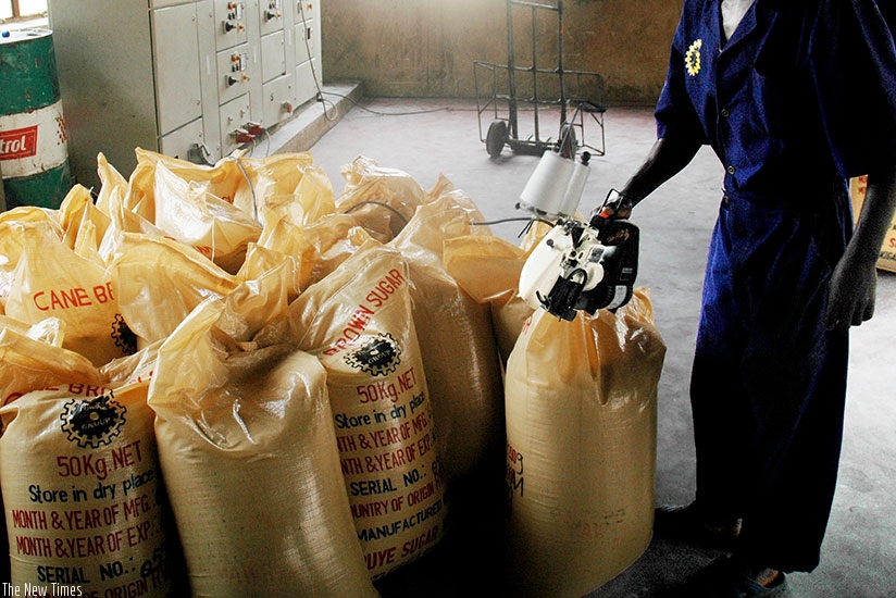 A man sealing sugar bags. The tax body is working with stakeholders in fight against fake VAT receipts. / File.