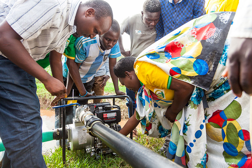 Farmers in Mimuli, Nyagatare test the new equipment on Monday. / Kelly Rwamapera