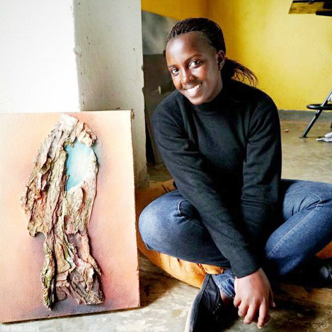 Hortance Kamikazi poses with one of her art pieces. / Courtesy