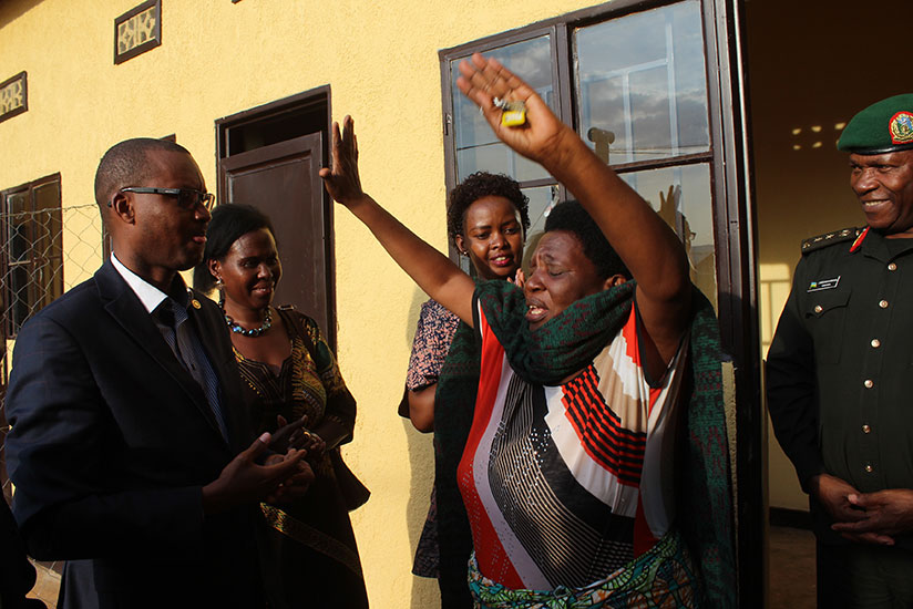 Uzamukosha (R) could not hide the joy after getting a house of her own. / Elias Hakizimana