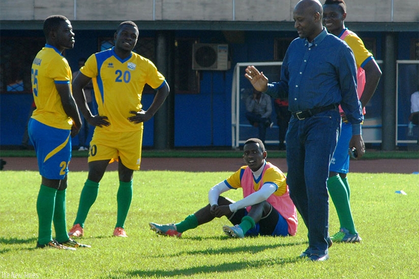 Vincent Nzamwita chats with Amavubi players during a past training camp at Amahoro National Stadium. The FERWAFA president is accused by rivals of not doing things the right way. File