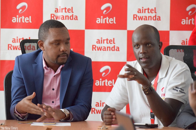John Magara, the Airtel head of branding and marketing (right), speaks at the conference yesterday, while left is Abindabizemu, the marketing director. (Frederic Byumvuhore.)