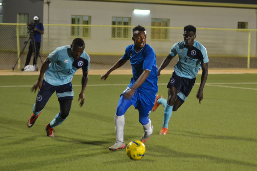 Rayon Sports' Savio Nshuti races away with the ball from Police defenders last week. The blues beat the cops side 3-0 and will hope to continue their winning start of the season ag....