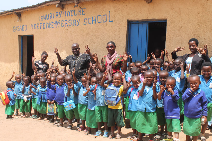 Pupils of Gasabo Independent Nursery school flash the V-sign with Hirwa and their teachers. / Moses Opobo