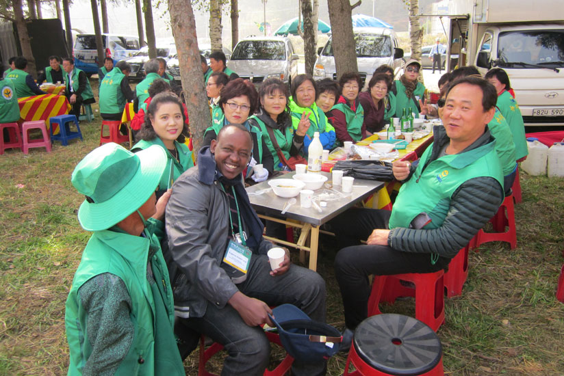 The New Times' Eugene Kwibuka poses for a photo with happy rural South Koreans.