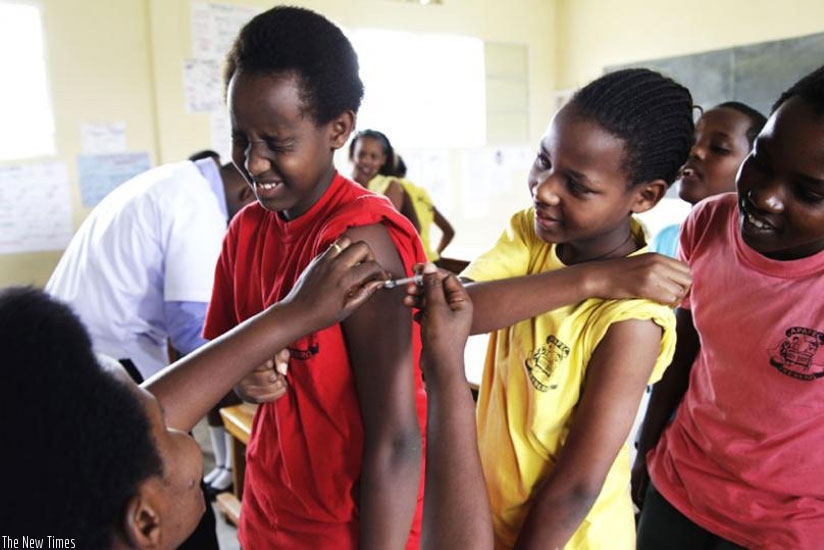 A nurse at Kagugu Health Centre immunises pupils of APAPEC IREBERO Primary School. (File photo)