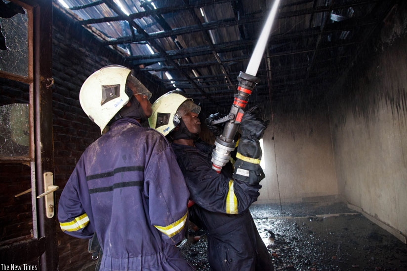 Fire fighters put out a fire in Nyabugogo last year. Most public buildings in Kigali still lack fire-fighting equipment as per a 2015 Ministerial Order. (File photo)
