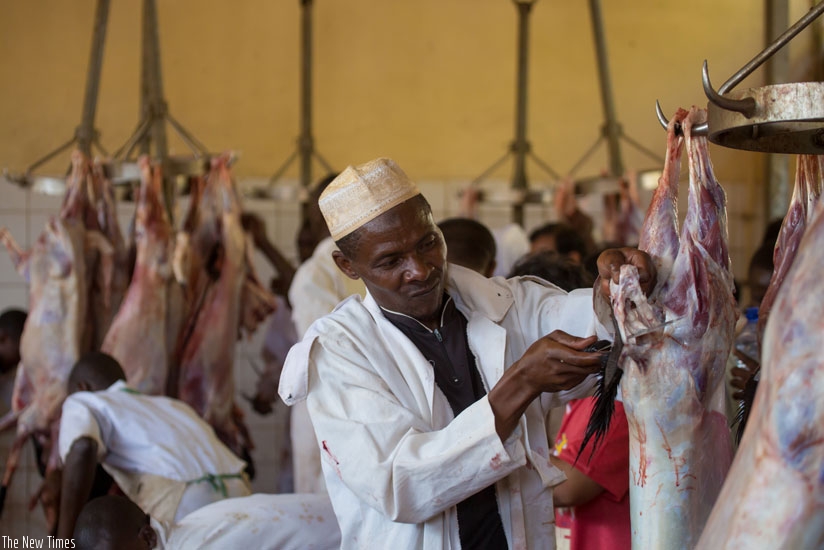 A butcher at work at an abattoir in Nyamirambo. The new project in Bugesera will surpass the country's meat production target which had been set at 230,000 tonnes per year. (File photo)