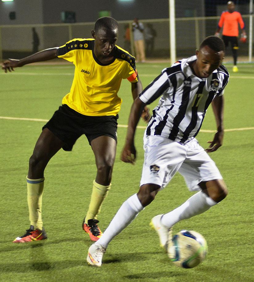 Maxime Sekamana of APR FC controls the ball against of Mukura VS captain Christophe Ndayishimiye on Friday at Kigali Regional Stadium. rn/ Sam Ngendahimana