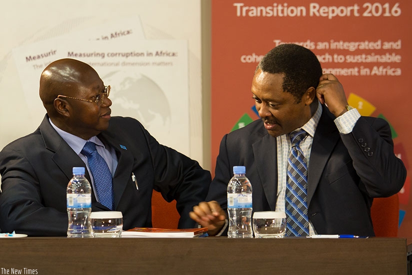 Manneh (L) chats with Prof. Shyaka during the launch of the report in Kigali last week. Timothy Kisambira.