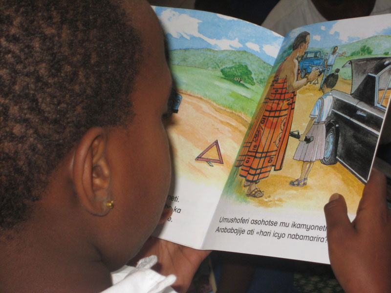 A child reads a Kinyarwanda story book. / File