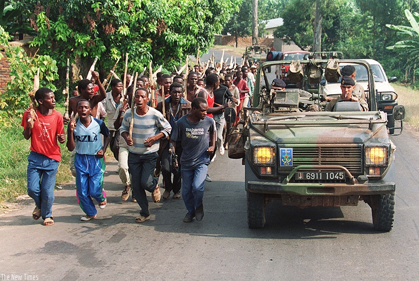 Interahamawe militia train in 1994 as French soldiers look on. (File)