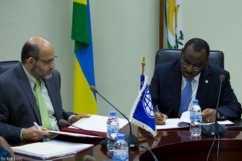 World Bank country manager Yasser El Gammal (L) and Finance and Economic Planning minister Claver Gatete sign the Rwf77 billion concessional loan agreement in Kigali yesterday. (Ti....