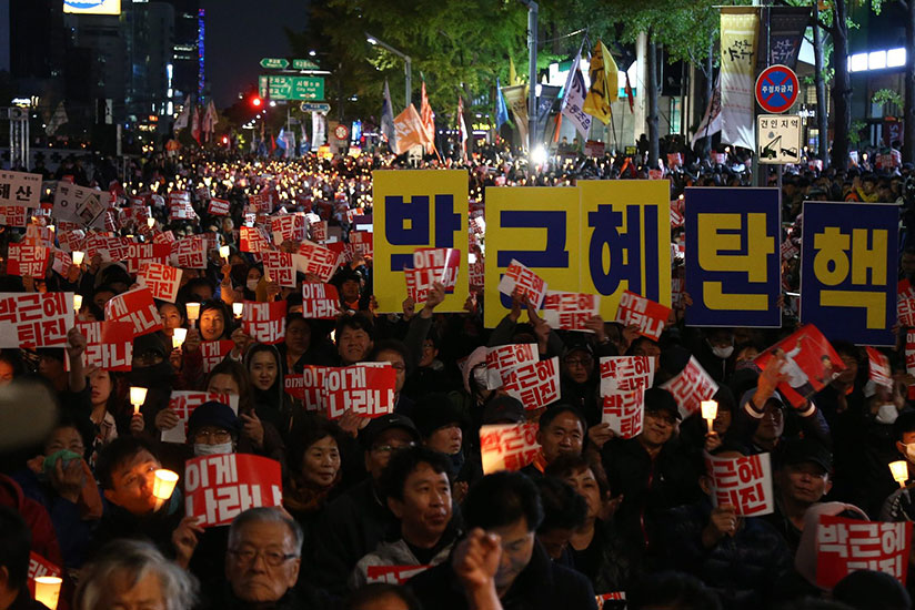 People holding placards reading 'Park Geun-Hye out' march in Seoul on Saturday. / Courtesy