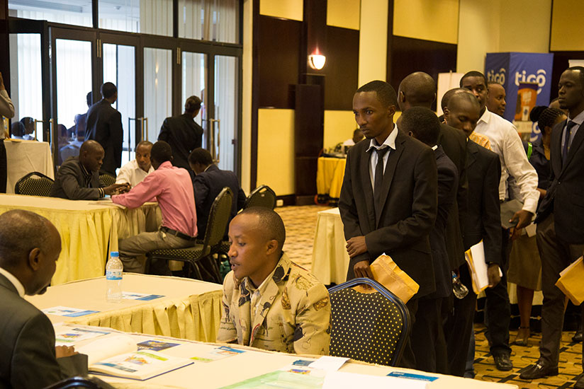 Youth queue at a desk at Kigali Serena Serena during last year's Job Day event. / Timothy Kisambira