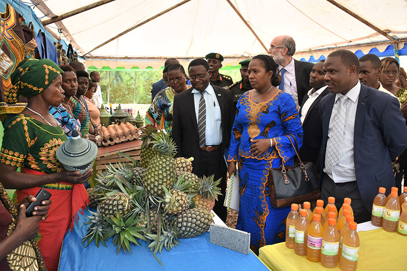 Uwamariya (second right), Belgian embassy officials and district leaders tour the exhibition. / John Mbaraga