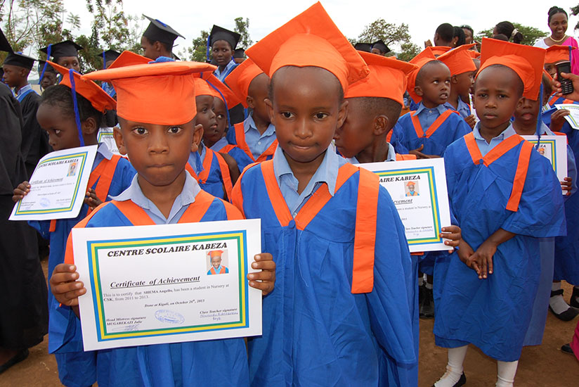Pupils of Centre Scolaire Kabeza, Kigali, display certificates of achievement they received at the end of the 2013 academic year. / Dennis Agaba