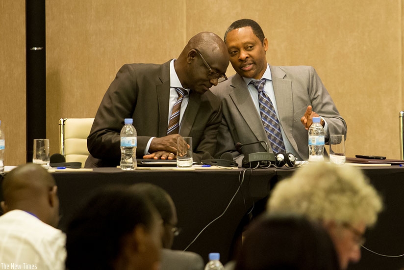 (L-R)  The guest of honour,  the Minister for Justice, Johnston Busingye chats with Anastase Shyaka, the CEO of Rwanda Governance Board  at the African Information Day celebrated in Kigali yesterday. (All photos by Timothy Kisambira.)