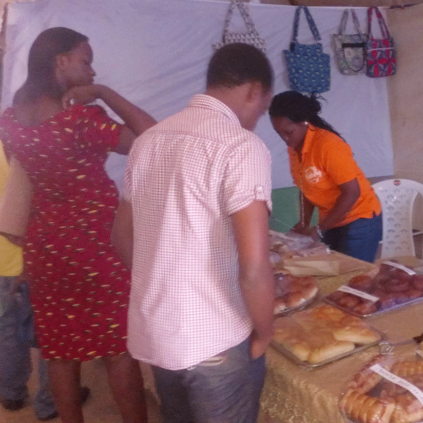 Some of the shoppers that  came to the trade fair yesterday admire cakes and other products. (Photos by Anitha Kirezi)