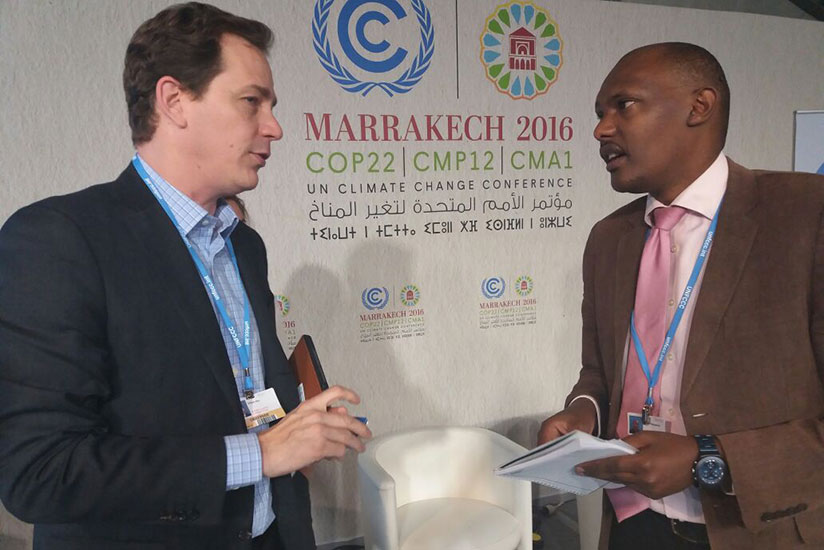 Philips Chief Marketing officer and head of strategy Bill Biene chats with Faustin Munyazikwiye, the REMA director of climate change and International obligations, during a session in Marrakech yesterday. rn/ Gashegu Muramira