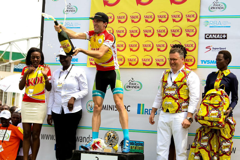 Team LowestRates' Timothy Rugg popping champagne after he won the prologue stage on Sunday. / Faustin Niyigena
