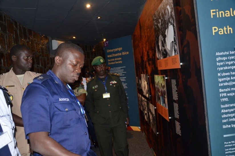 A course participant takes time to read the explanations on the different stages of the Genocide against the Tutsi.