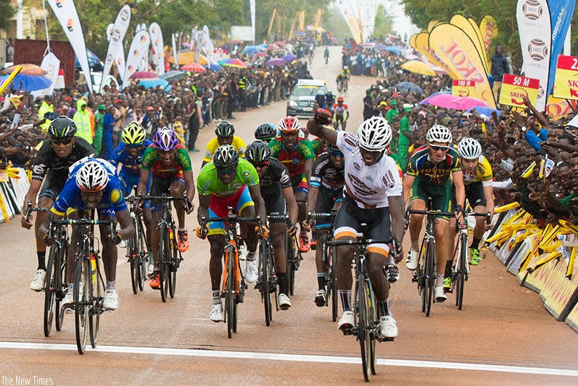 Joseph Areruya crosses first the finishing line of stage four in Huye town yesterday. (All photos by Faustin Niyigena)