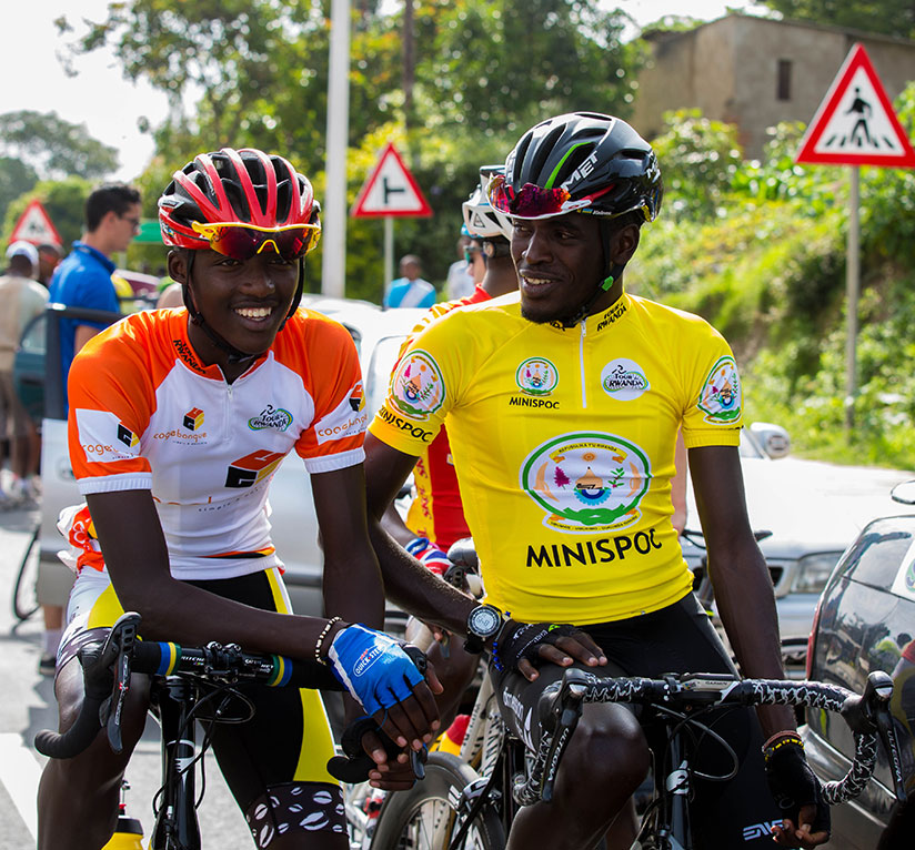 The 2016 Tour du Rwanda race leader Valens Ndayisenga (R) chats with Samuel Mugisha, the best climber, before the start of stage 4. / Faustin Niyigena