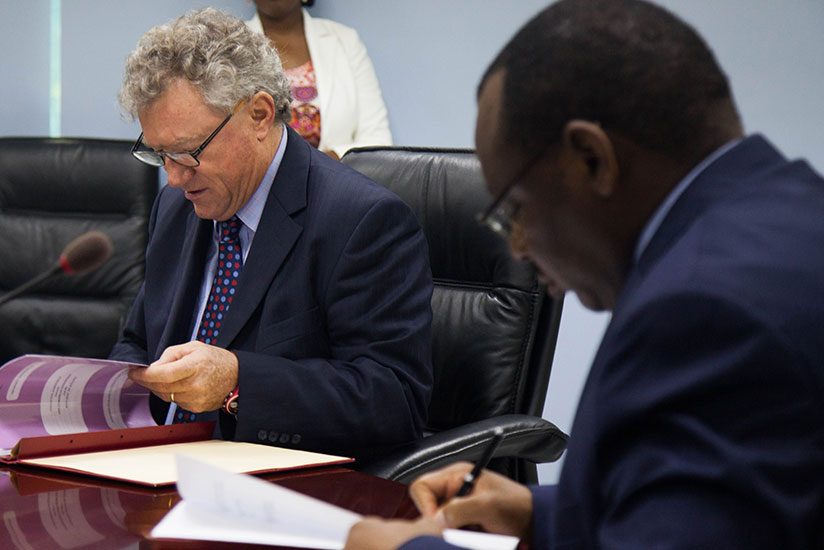 Finance Minister Gatete (right) and Ryan, the Head of the EU Delegation sign deal documents yesterday. / Nadege Imbabazi