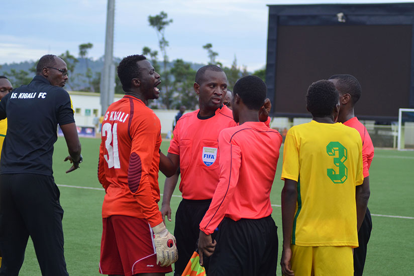AS Kigali players, including Ndoli (middle) are restrained by the match officials as tempers flared during the match against Rayon Sports. / Sam Ngendahimana