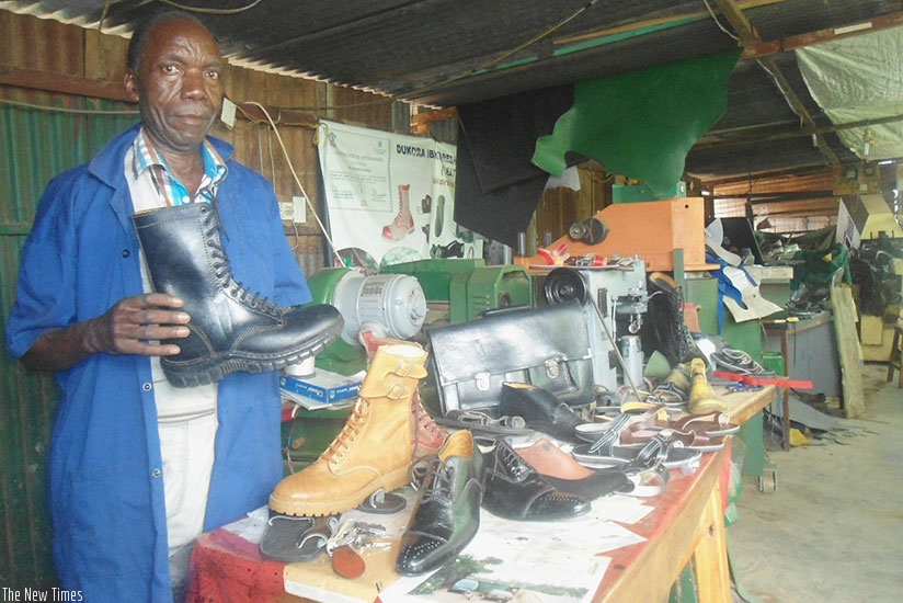 Juvenal Gatorano, the proprietor of Nyamirambo-based Atelier de Gatorano, which makes leather products, at his workshop. The expos enable people, like Gatorano, to penetrate other markets. (Remy Niyingize.)